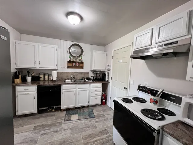a kitchen with stainless steel appliances granite countertop a stove and a microwave