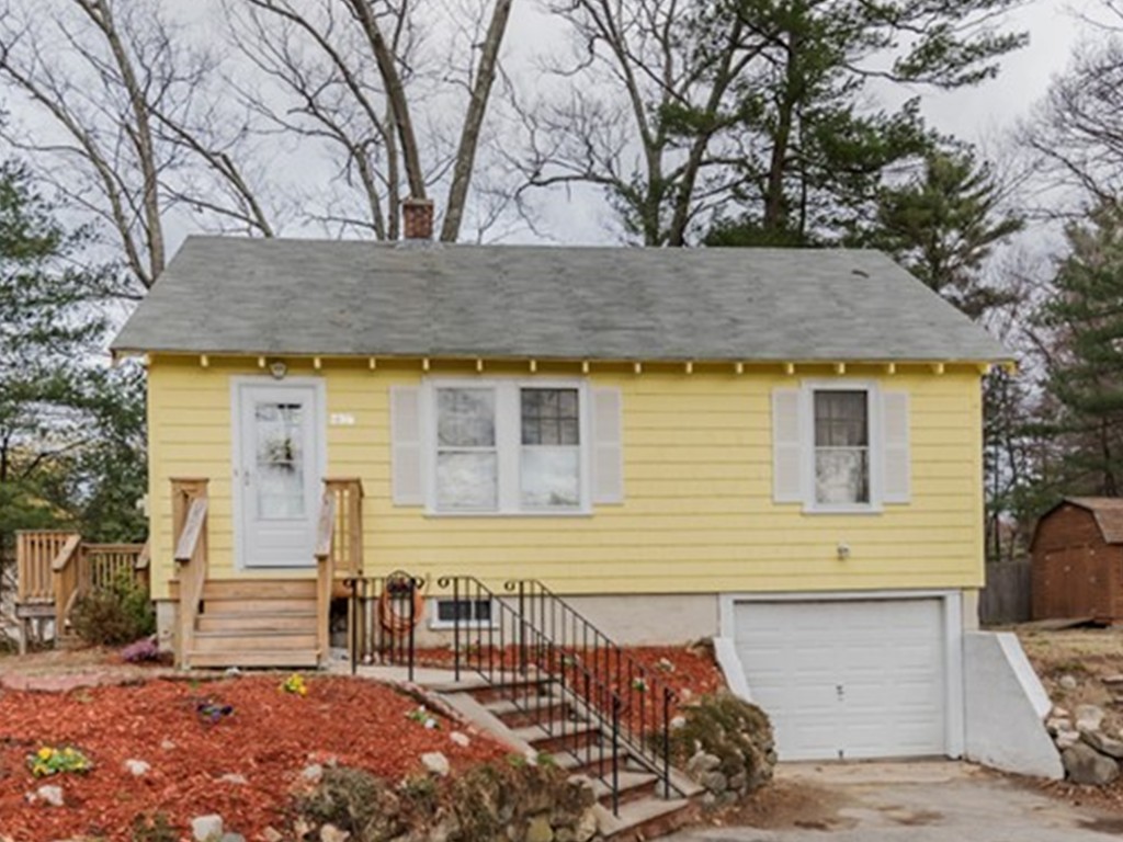338 Andover Road Billerica, MA 01821 - Photo 1 of 16 a view of a house with large windows and a tree