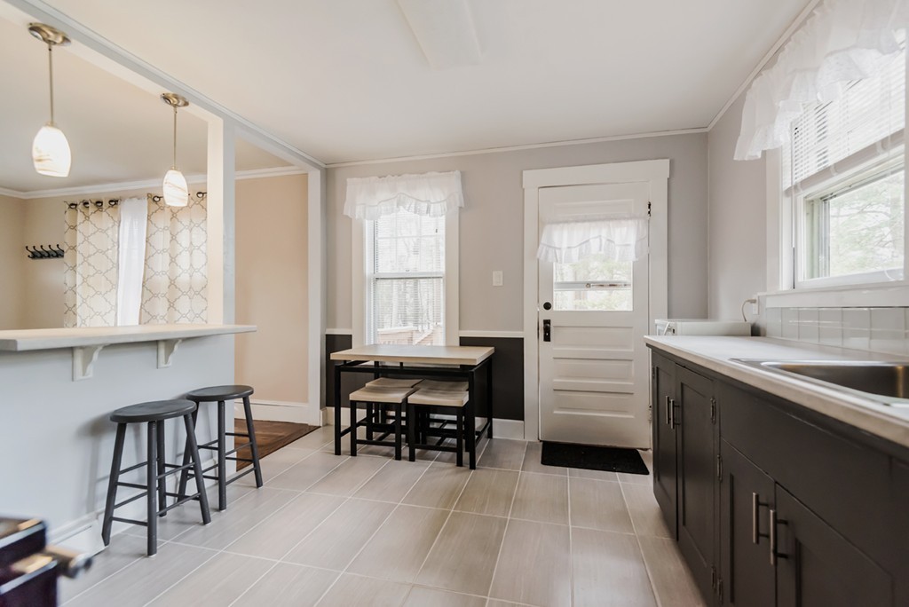 338 Andover Road Billerica, MA 01821 - Photo 11 of 16 a kitchen with sink cabinets and dining table