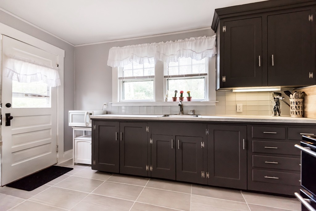 338 Andover Road Billerica, MA 01821 - Photo 12 of 16 a kitchen with a sink wooden cabinets and a window