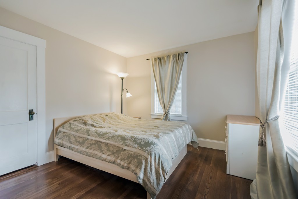 338 Andover Road Billerica, MA 01821 - Photo 13 of 16 a bedroom with a bed and wooden floor