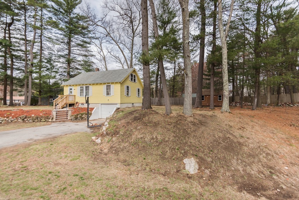338 Andover Road Billerica, MA 01821 - Photo 4 of 16 a backyard of a house with table and chairs