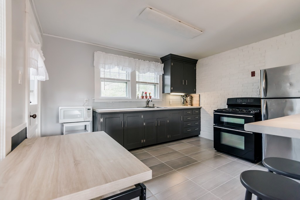 338 Andover Road Billerica, MA 01821 - Photo 9 of 16 a kitchen with a sink appliances and cabinets