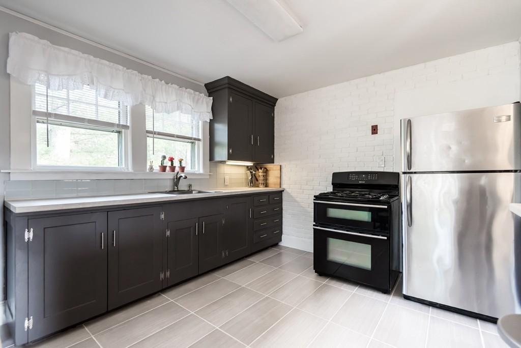 338 Andover Road Billerica, MA 01821 - Photo 10 of 16 a kitchen with a refrigerator and a sink