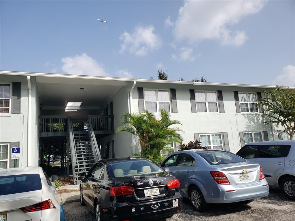 4886 South Conway Road, Unit 76 Orlando, FL 32812 - Photo 4 of 12 a front view of a house with parking