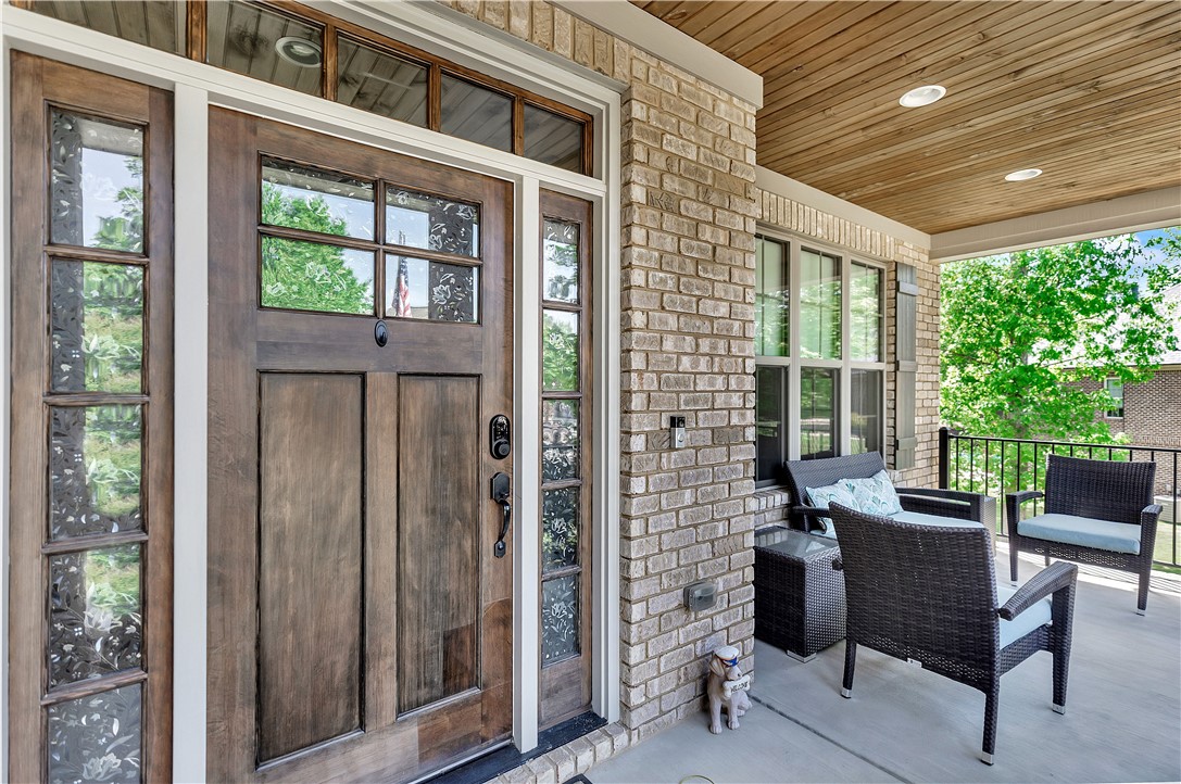 10 Colonel Storrs Court Greer, SC 29650 - Photo 2 of 48 Entertain guests on this spacious front porch, offering comfortable seating and lush green views.
