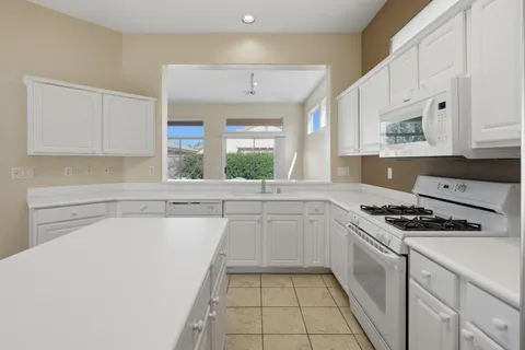 a spacious bathroom with a shower sink and mirror
