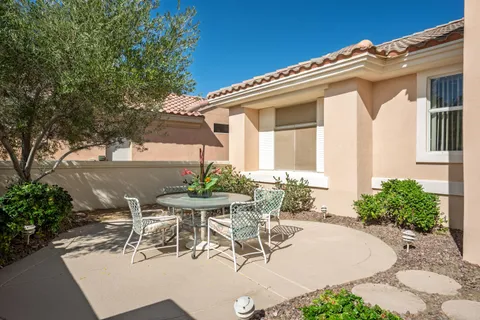 a view of a patio with table and chairs and potted plants