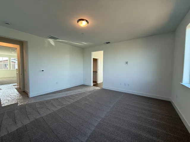 a large bathroom with double vanity sinks a large mirror and a bathtub