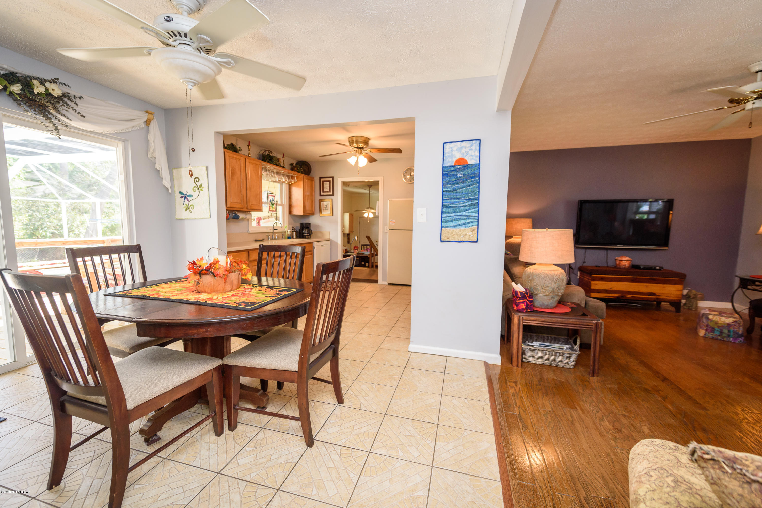 249 Bonita Road St. Augustine, FL 32086 - Photo 14 of 46 a dining room with furniture a chandelier and wooden floor