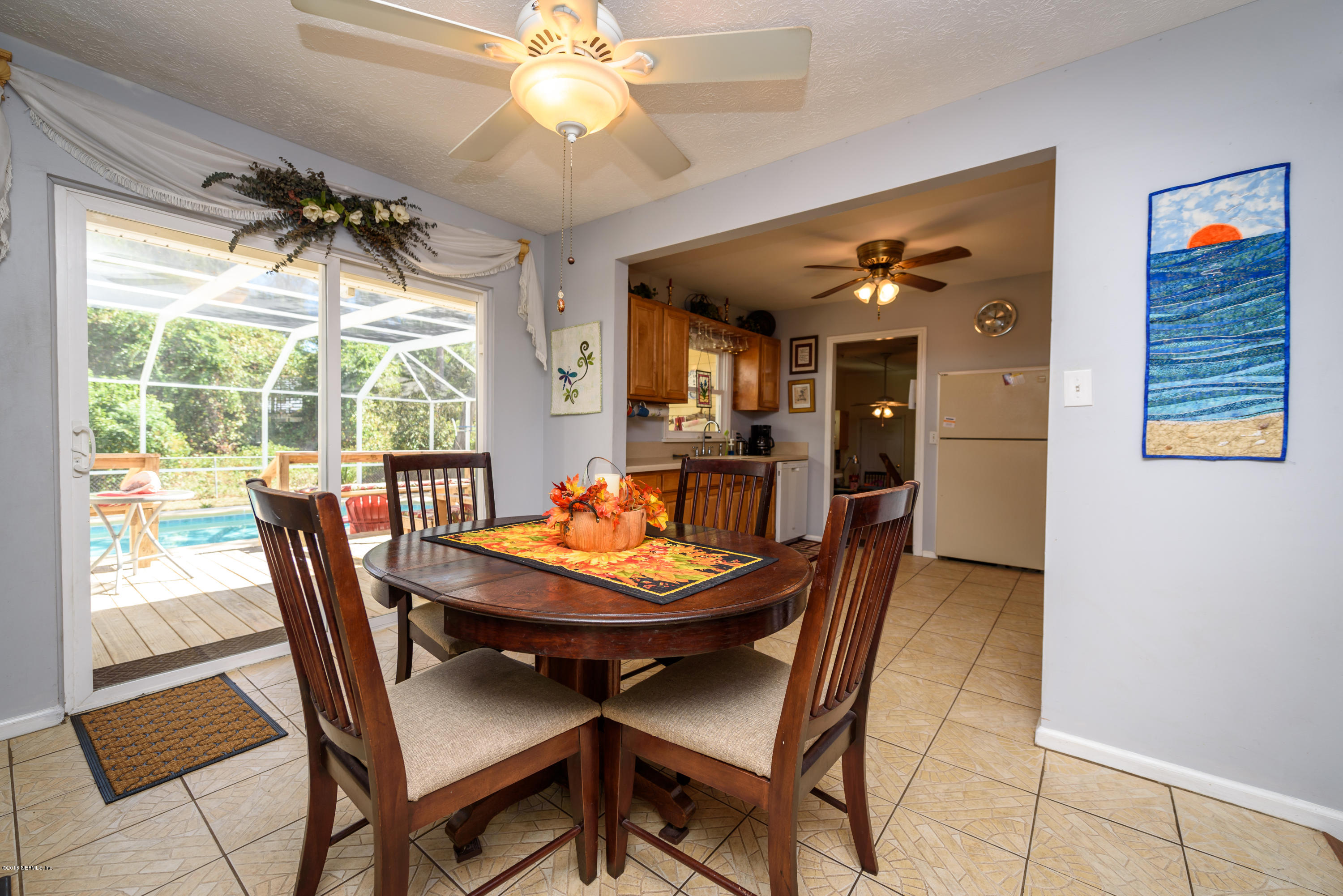 249 Bonita Road St. Augustine, FL 32086 - Photo 15 of 46 a dining room with furniture a chandelier and window
