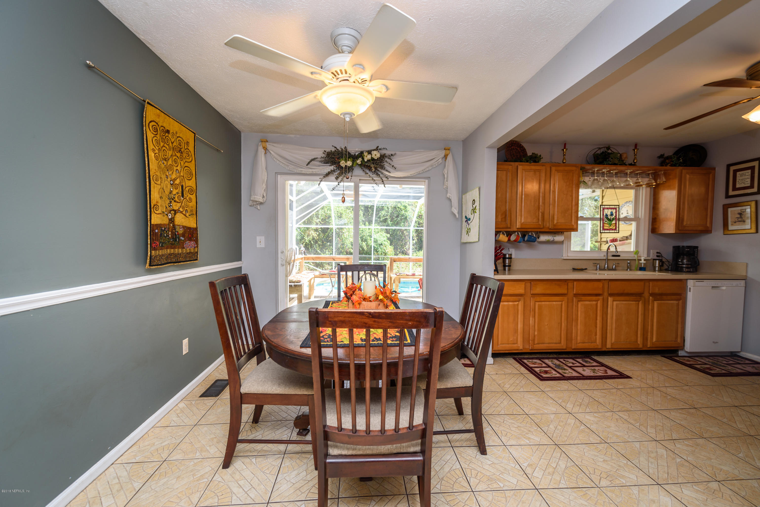 249 Bonita Road St. Augustine, FL 32086 - Photo 16 of 46 a view of a dining room with furniture and chandelier