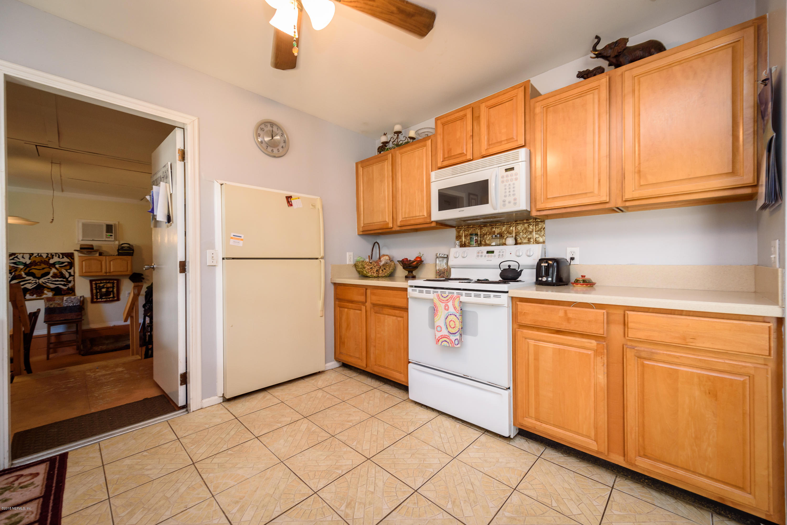 249 Bonita Road St. Augustine, FL 32086 - Photo 21 of 46 a kitchen with stainless steel appliances granite countertop a refrigerator sink and cabinets