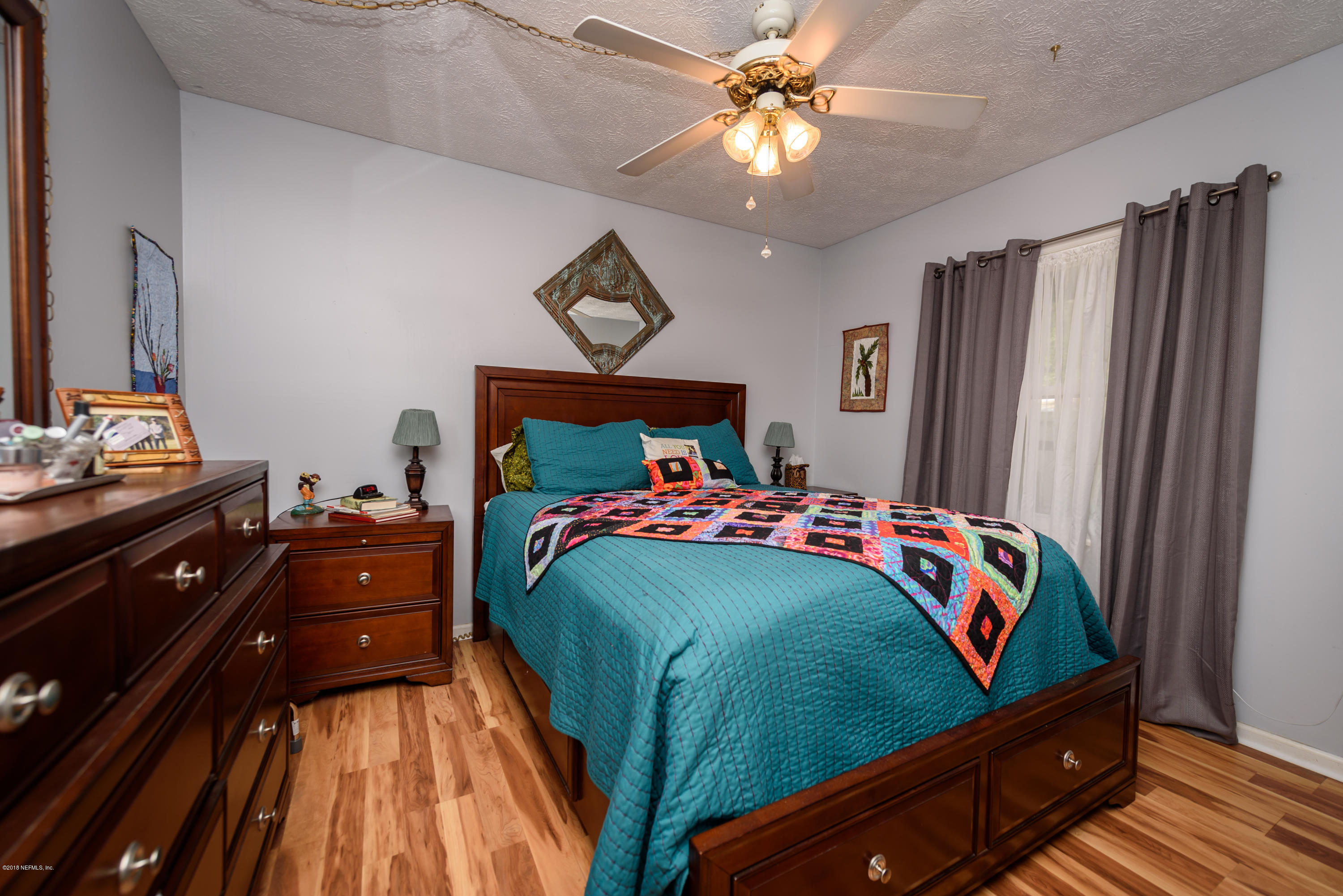 249 Bonita Road St. Augustine, FL 32086 - Photo 23 of 46 a bedroom with a bed and a chandelier