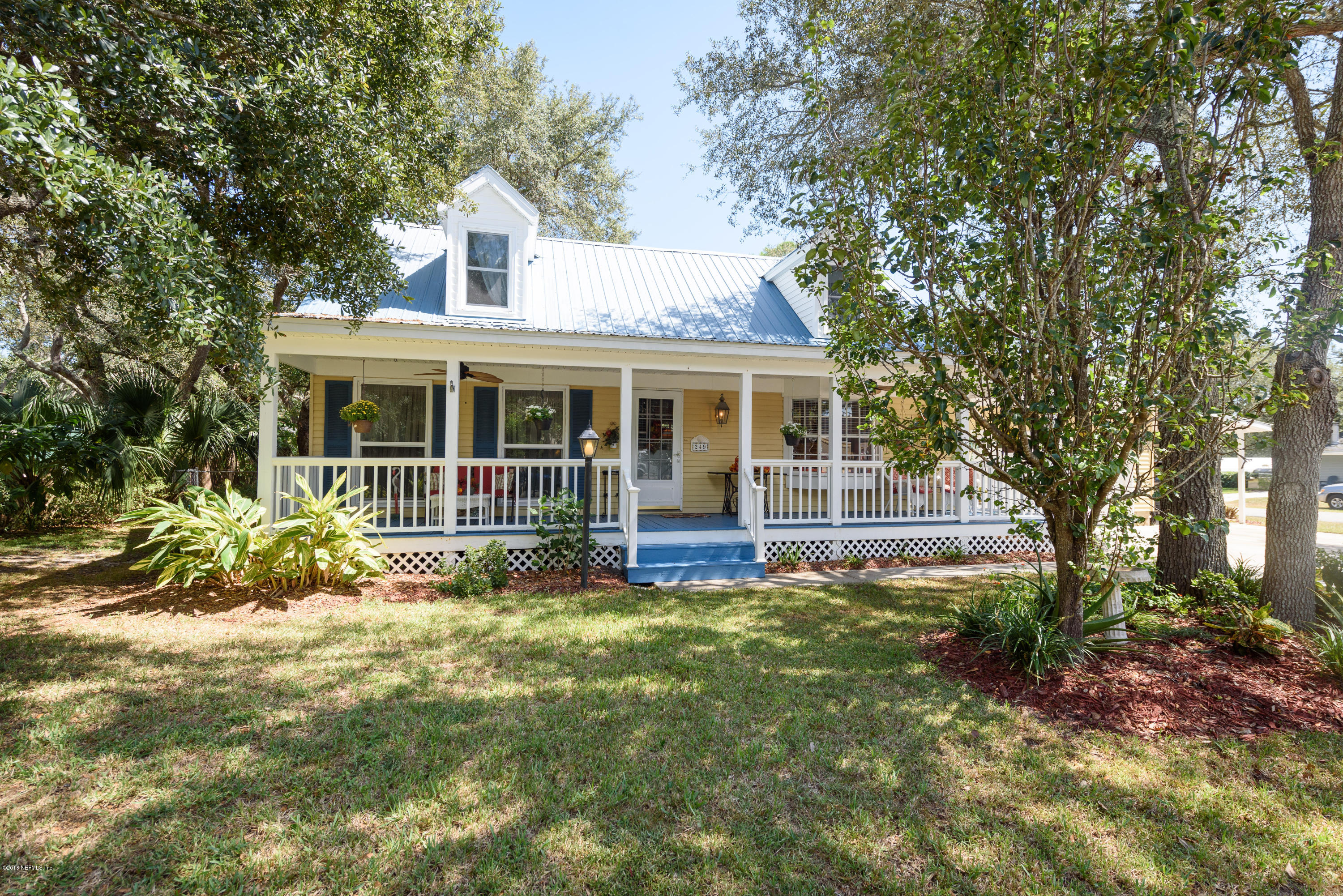 249 Bonita Road St. Augustine, FL 32086 - Photo 5 of 46 a view of house in front of a big yard with large trees and plants