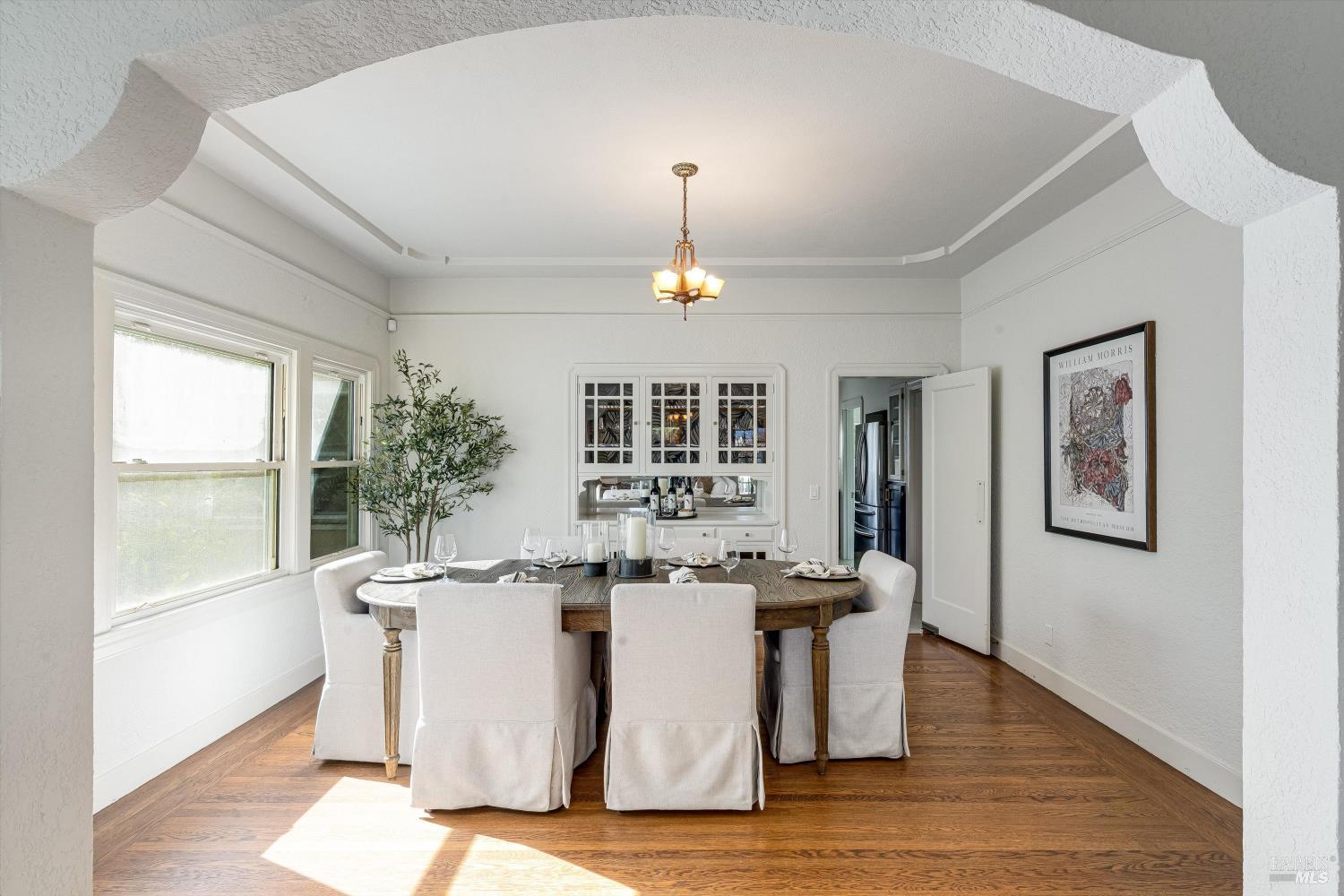 1709 Spring Mountain Road St. Helena, CA 94574 - Photo 12 of 48 a dining room with wooden floor and chandelier