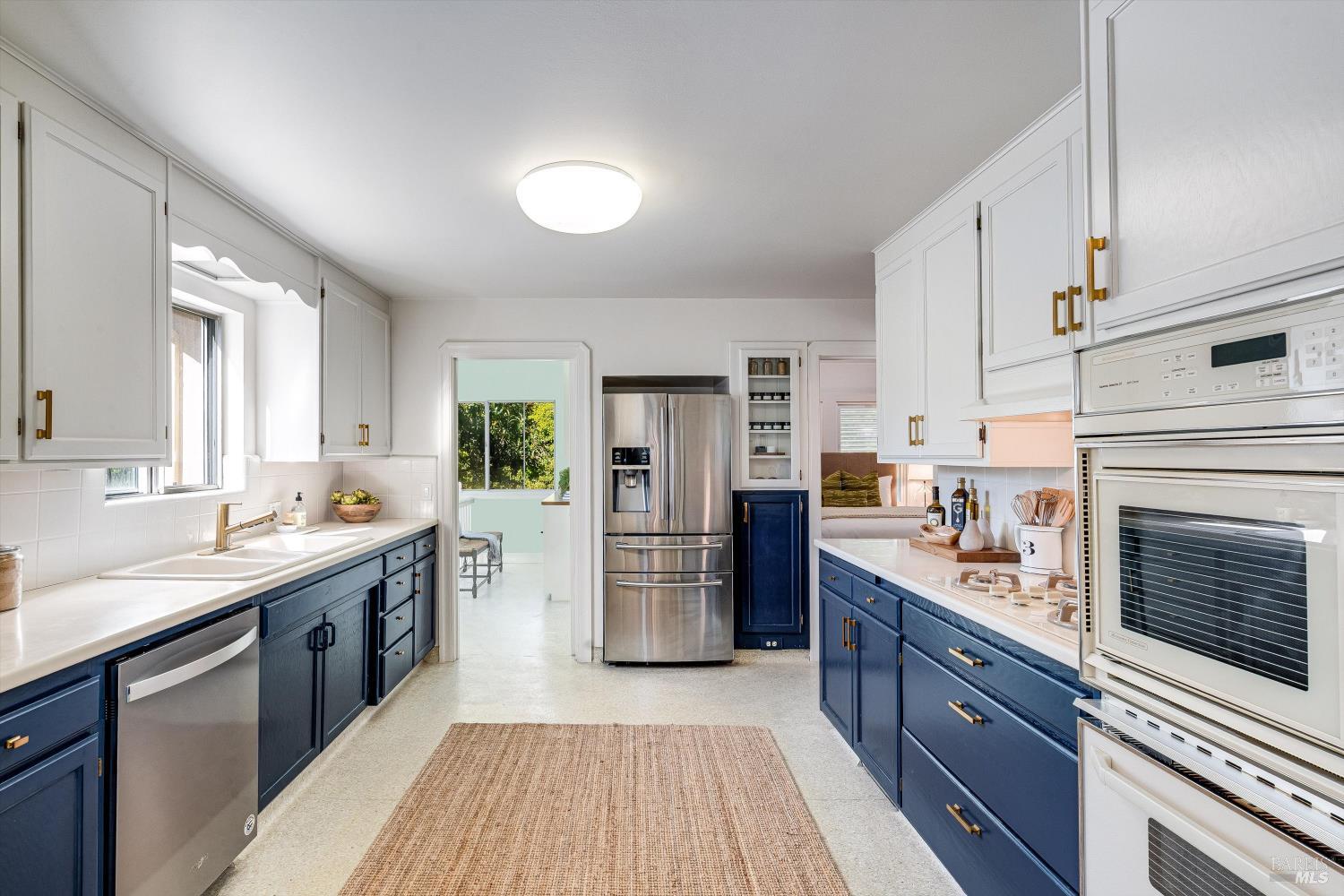 1709 Spring Mountain Road St. Helena, CA 94574 - Photo 18 of 48 a kitchen with stainless steel appliances granite countertop a stove top oven a sink dishwasher a refrigerator and a cabinets with wooden floor