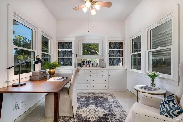 a workspace with furniture window and wooden floor