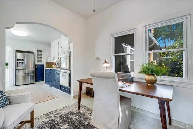 a living room with furniture and large windows