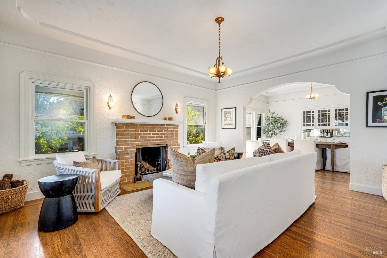 1709 Spring Mountain Road St. Helena, CA 94574 - Photo 6 of 48 a living room with furniture a fireplace and a chandelier
