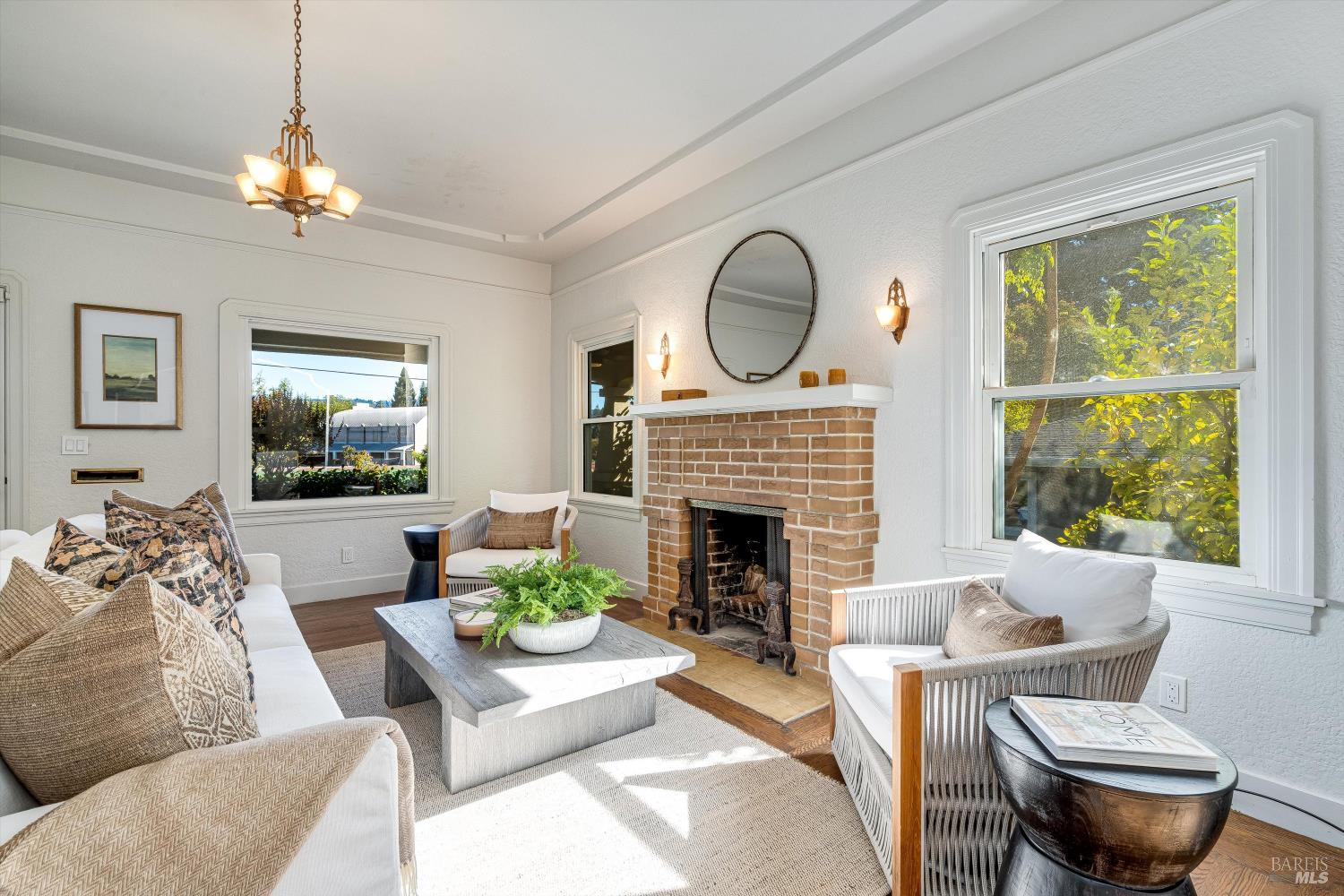 1709 Spring Mountain Road St. Helena, CA 94574 - Photo 10 of 48 a living room with furniture a fireplace and a flat screen tv