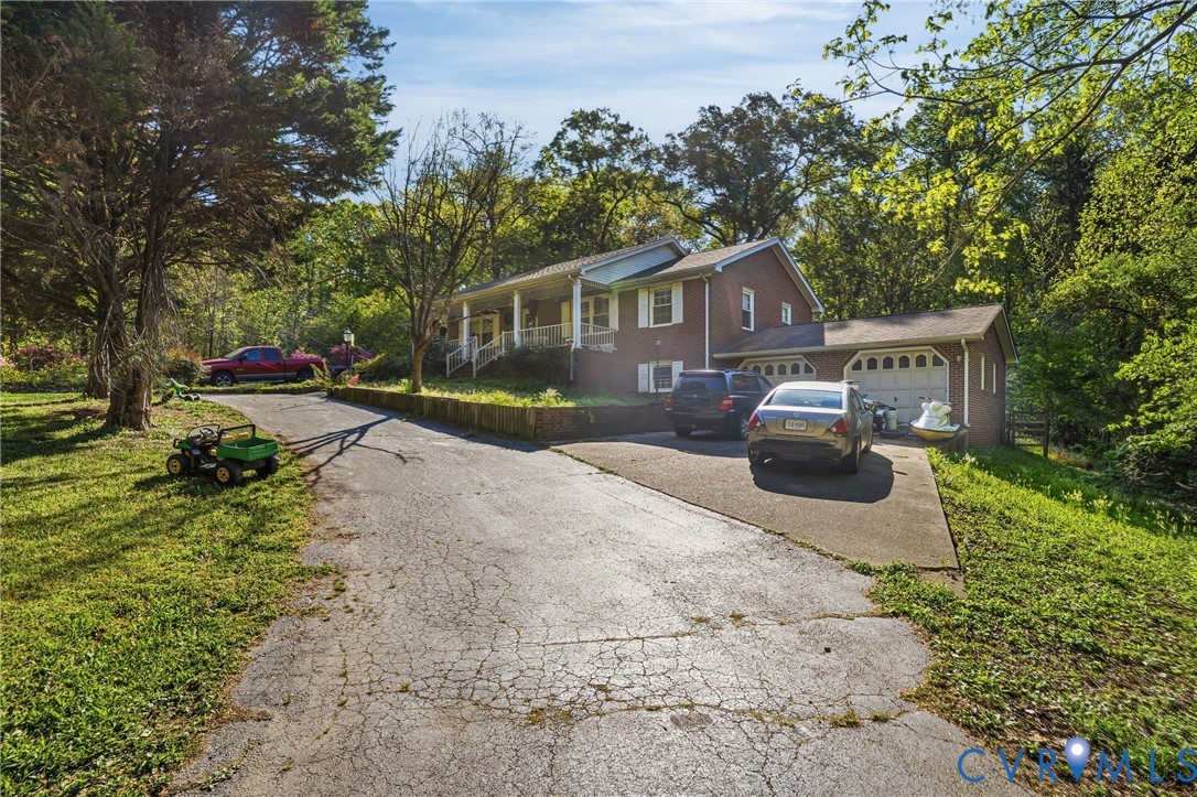 14219 Spruce Avenue Chester, VA 23836 - Photo 3 of 32 a front view of a house with a yard and trees