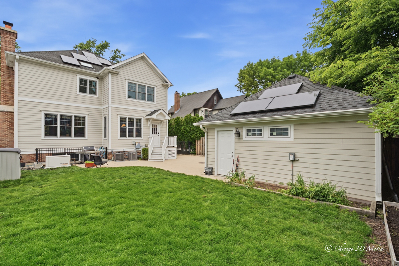 306 17th Street Wilmette, IL 60091 - Photo 4 of 48 a front view of a house with a garden and plants