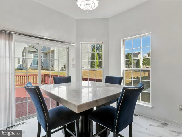 a kitchen with stainless steel appliances granite countertop a stove refrigerator and microwave