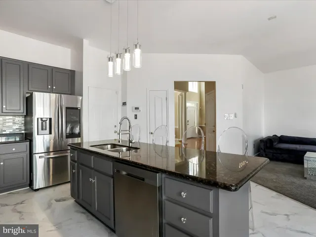 a living room with furniture a fireplace and a floor to ceiling window