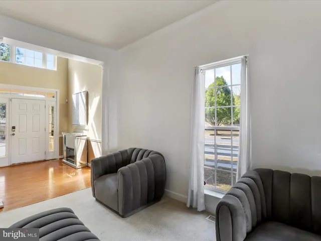 a living room with furniture a couch and large window