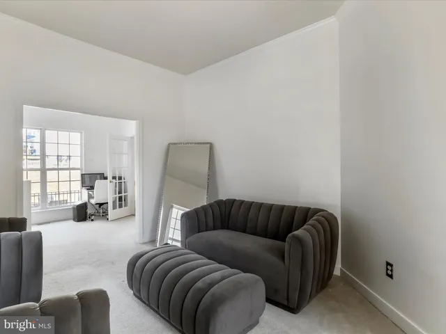 a view of a livingroom with wooden floor and a window