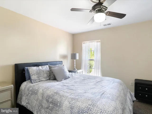 a bedroom with a large bed and a window