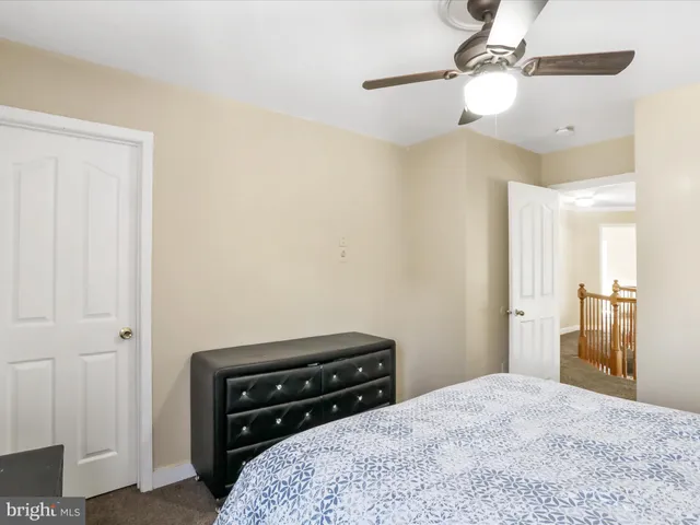 a spacious bedroom with a bed and a window