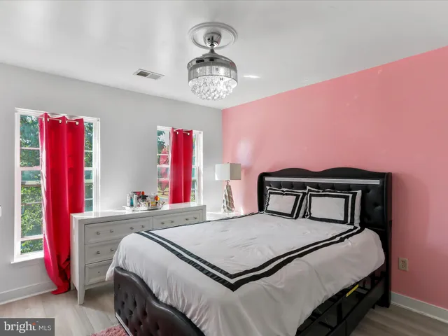 a spacious bathroom with a tub double sink window and mirror