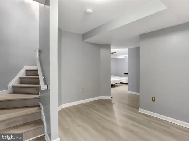 a bedroom with a bed a flat screen tv and a chandelier