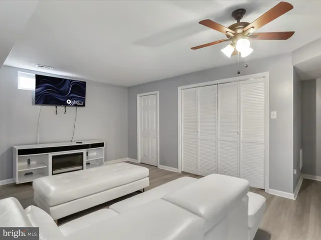 a bedroom with a bed and a ceiling fan