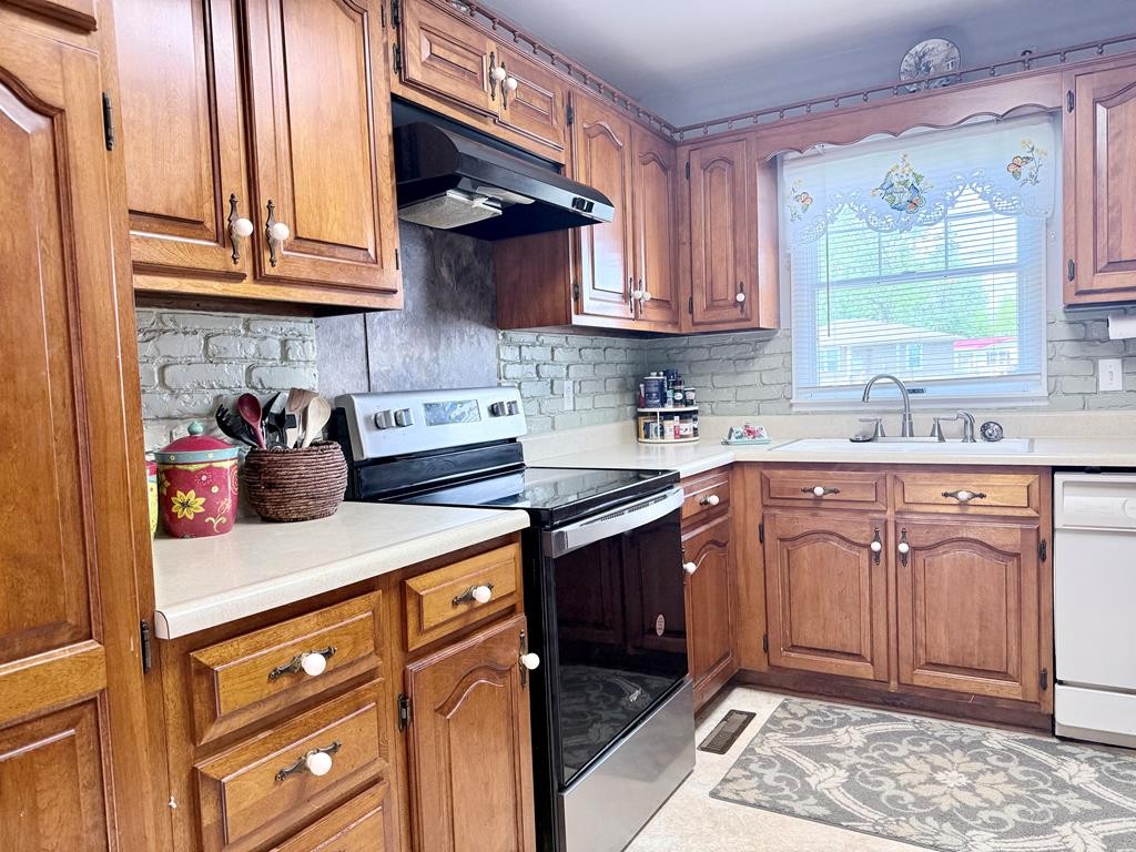 137 Dripping Springs Street Crofton, KY 42217 - Photo 25 of 51 a kitchen with stainless steel appliances granite countertop a sink stove and cabinets