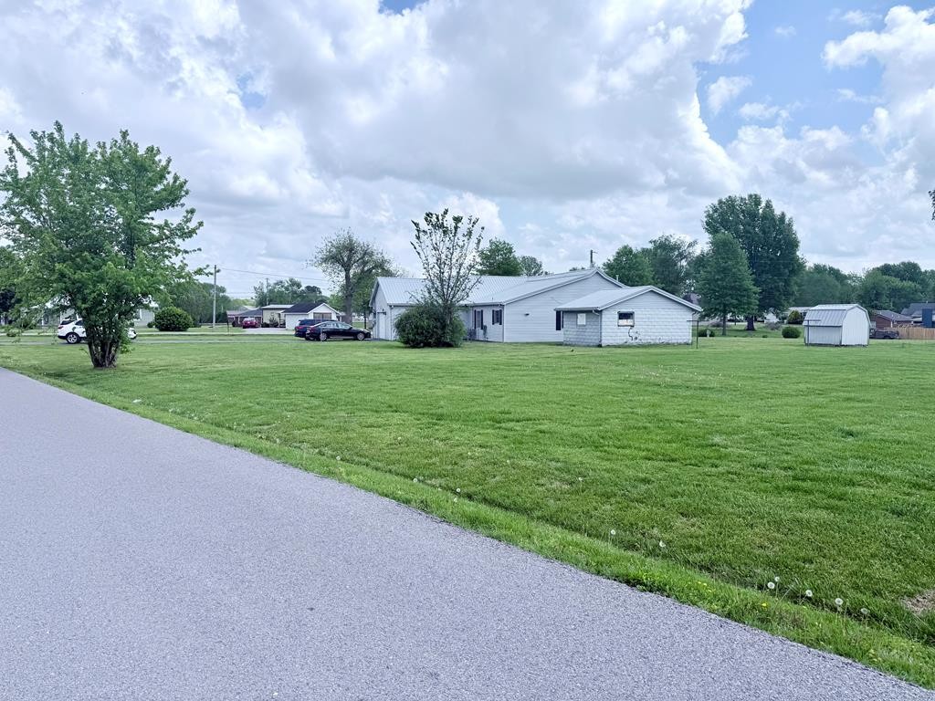 137 Dripping Springs Street Crofton, KY 42217 - Photo 44 of 51 a view of a house with a big yard and a fountain