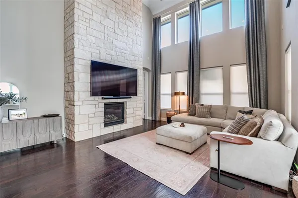 a living room with furniture a flat screen tv and a fireplace