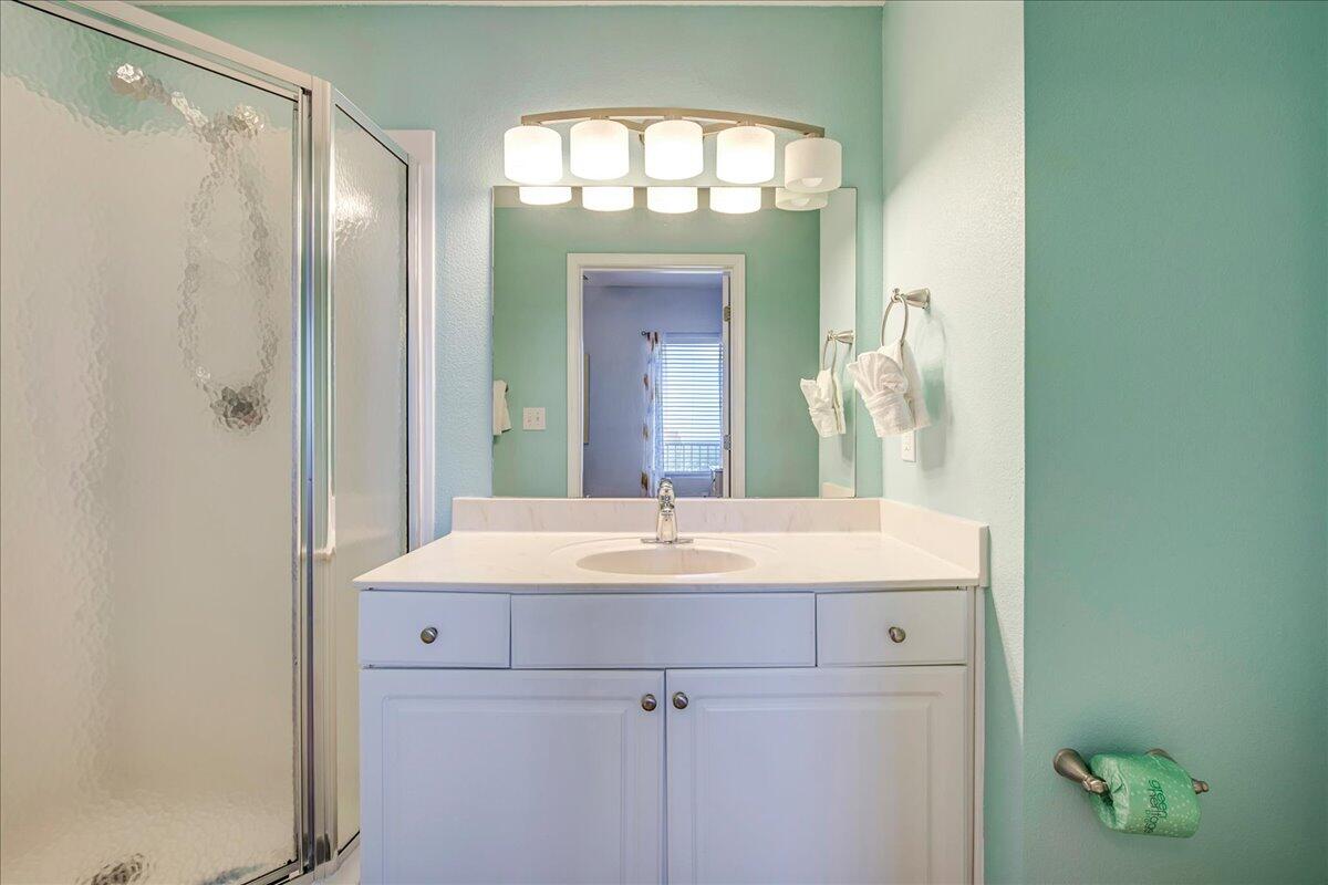16819 Front Beach Road, Unit 2210 Panama City Beach, FL 32413 - Photo 13 of 30 a bathroom with a sink and a mirror