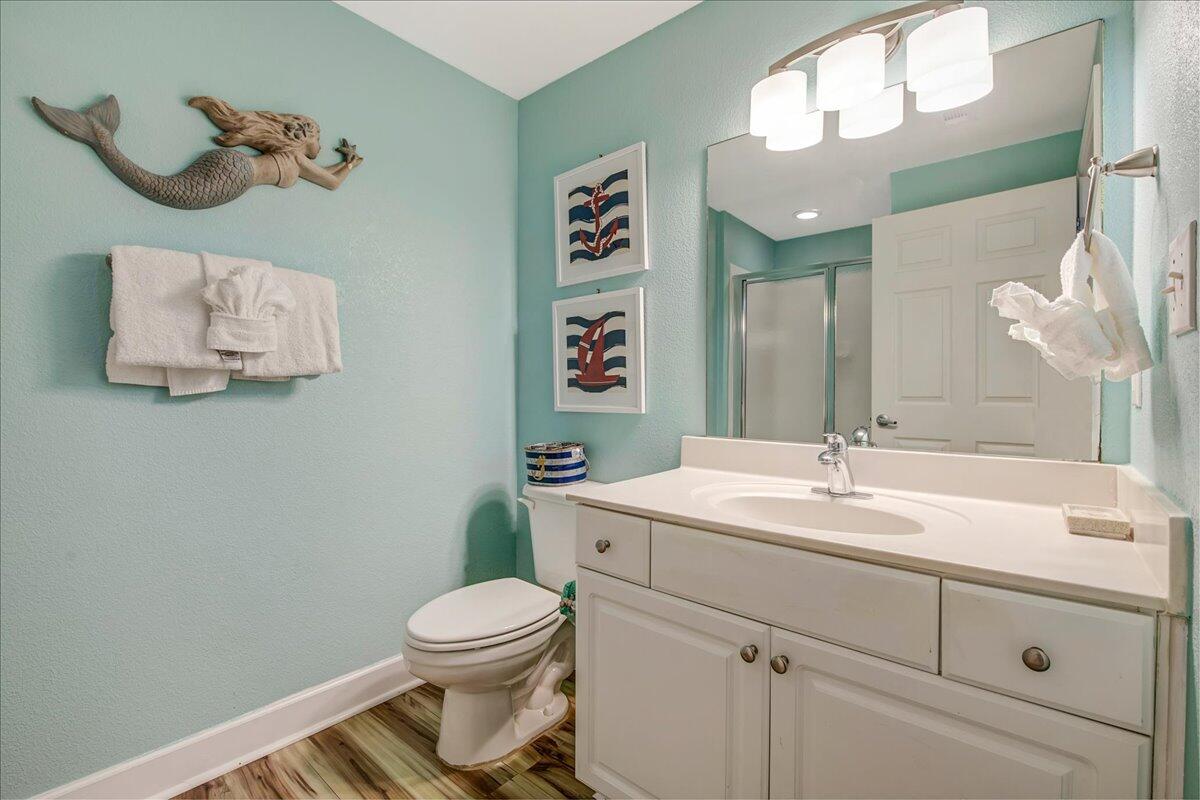 16819 Front Beach Road, Unit 2210 Panama City Beach, FL 32413 - Photo 15 of 30 a bathroom with a toilet sink vanity and mirror