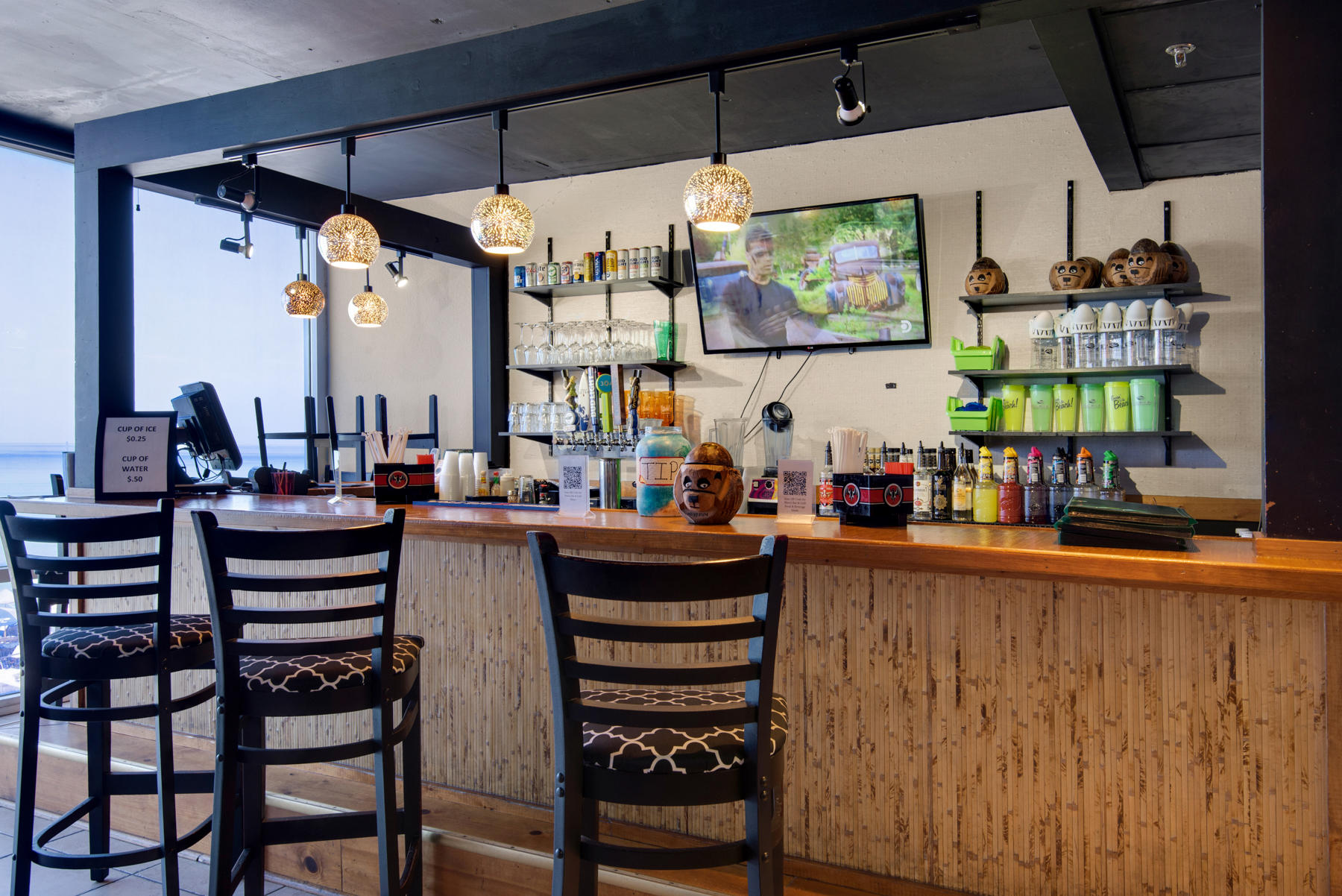 16819 Front Beach Road, Unit 2210 Panama City Beach, FL 32413 - Photo 16 of 30 a kitchen with stainless steel appliances kitchen island granite countertop a table and chairs in it