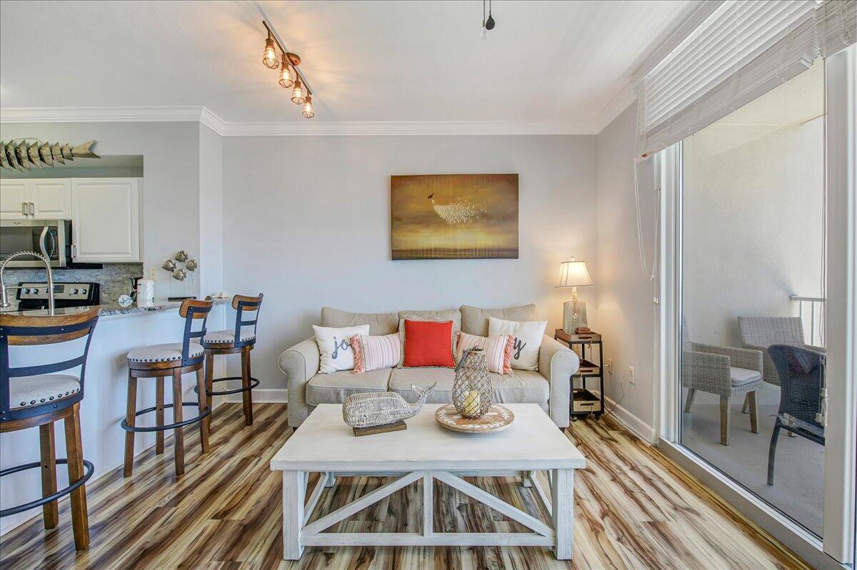 16819 Front Beach Road, Unit 2210 Panama City Beach, FL 32413 - Photo 5 of 30 a view of a dining room with furniture and wooden floor