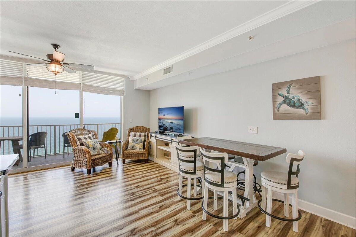 16819 Front Beach Road, Unit 2210 Panama City Beach, FL 32413 - Photo 6 of 30 a view of a dining room with furniture window and wooden floor