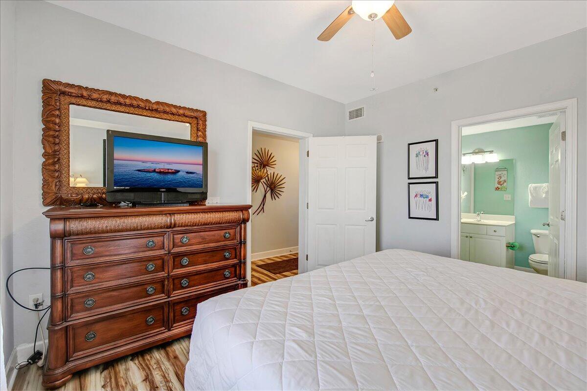 16819 Front Beach Road, Unit 2210 Panama City Beach, FL 32413 - Photo 10 of 30 a bedroom with a bed and a flat screen tv
