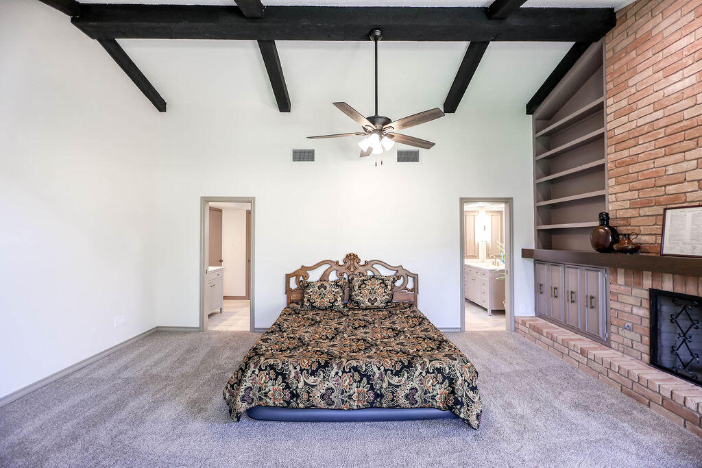 4106 64th Street Lubbock, TX 79413 - Photo 11 of 60 a bedroom with a bed and a fireplace