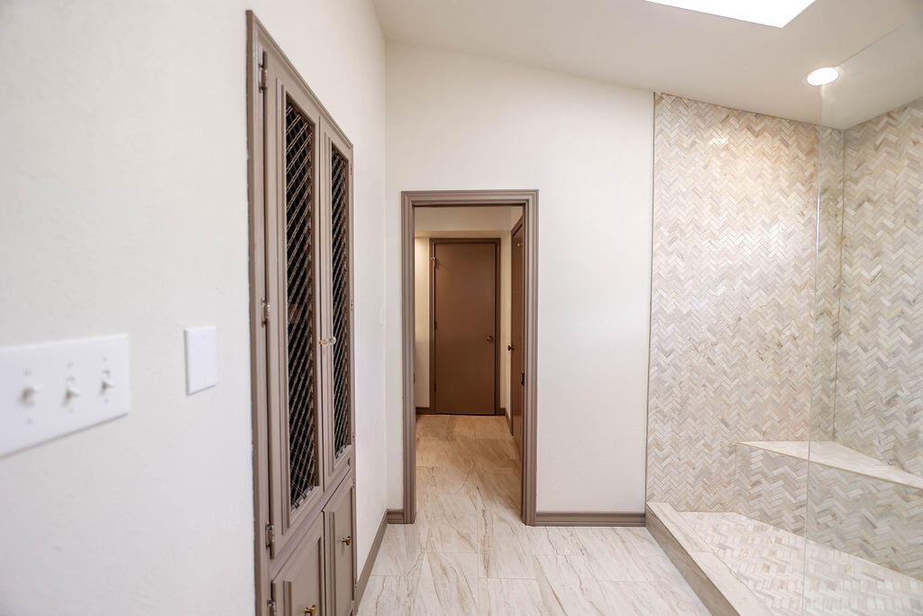 4106 64th Street Lubbock, TX 79413 - Photo 16 of 60 a view of a hallway with wooden floor and a bathroom