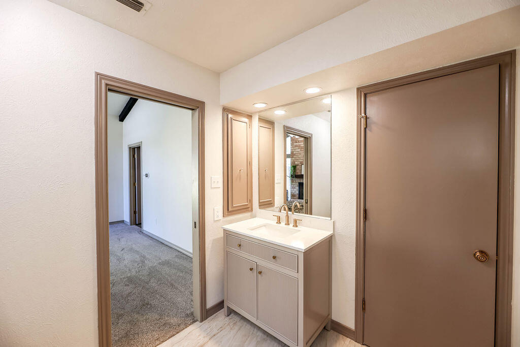 4106 64th Street Lubbock, TX 79413 - Photo 19 of 60 a bathroom with a double vanity sink and mirror