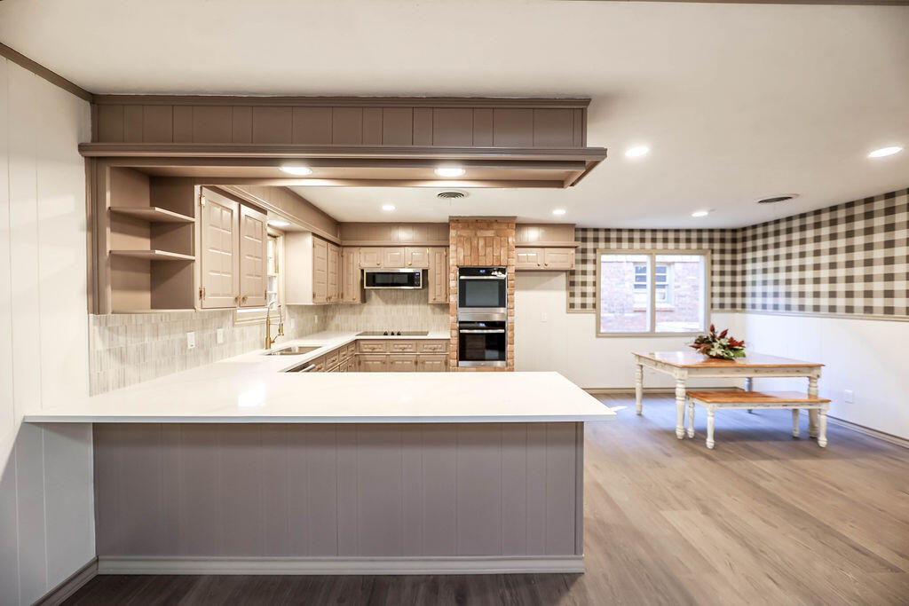 4106 64th Street Lubbock, TX 79413 - Photo 23 of 60 a large kitchen with a table and chairs