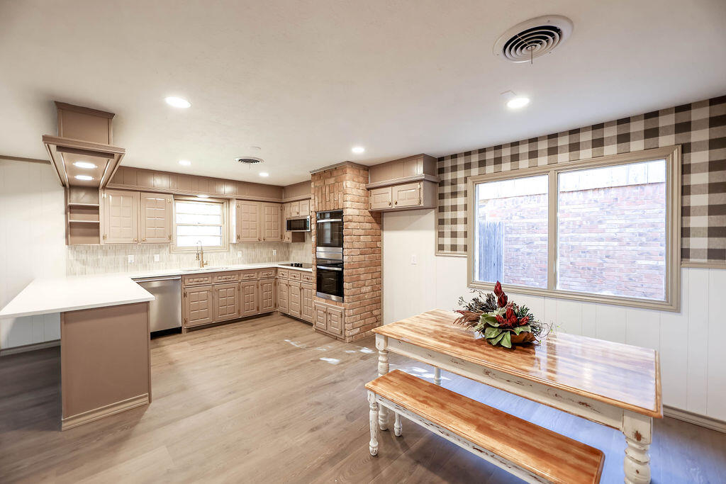 4106 64th Street Lubbock, TX 79413 - Photo 25 of 60 a kitchen with a refrigerator and a stove